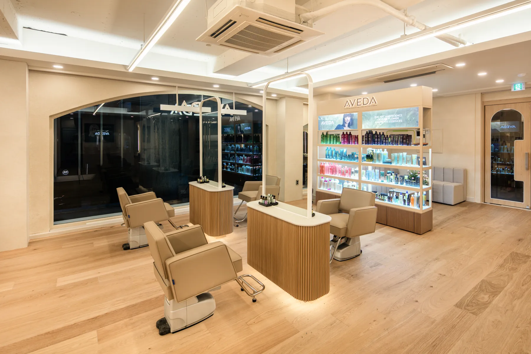 Styling chair beside the AVEDA product wall · RARIEN Gangnam